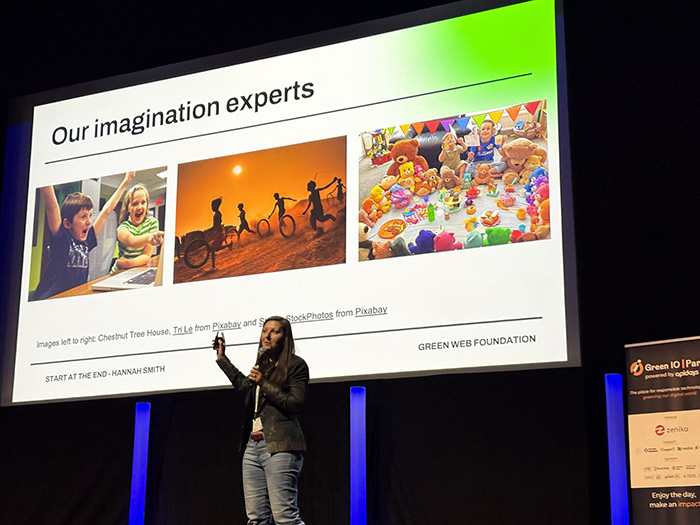 Hannah Smith on stage with a slide behind her titled Our imagination experts and three pictures of children playing